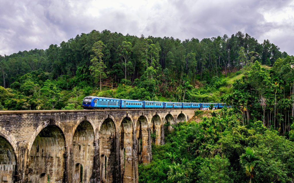 The famous 9 arches bridge in Ella, Sri Lanka, with a blue train passing by