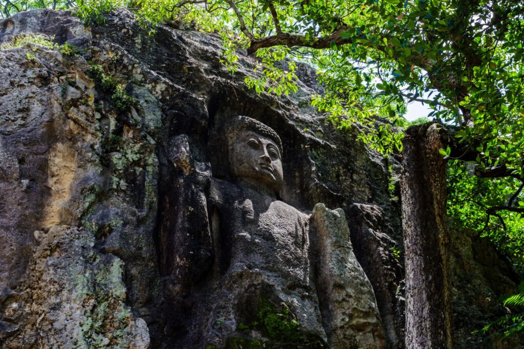 Ancient rock-carved Buddha statue at Dhowa Rock Temple, Ella, Sri Lanka