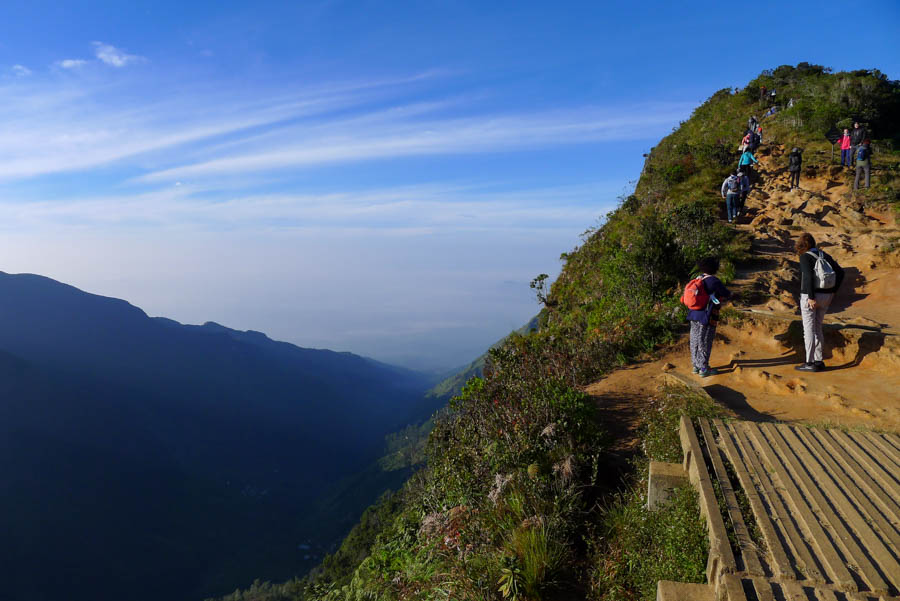 Traveler standing at World’s End in Horton Plains National Park, Sri Lanka, admiring the view.