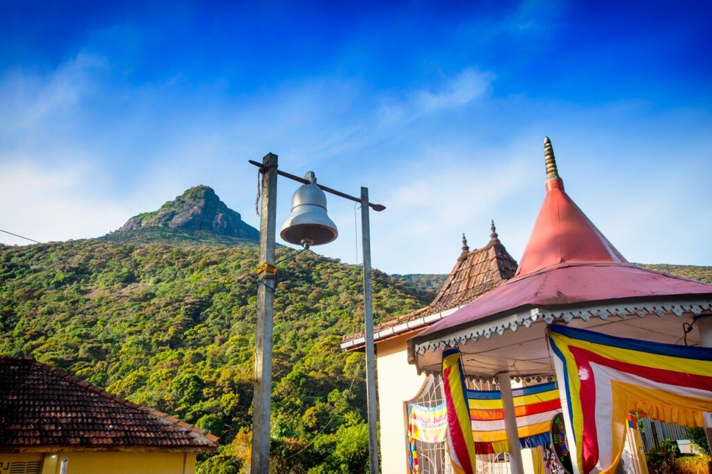 View of Adam's Peak from far during the day with buildings at closer distance.